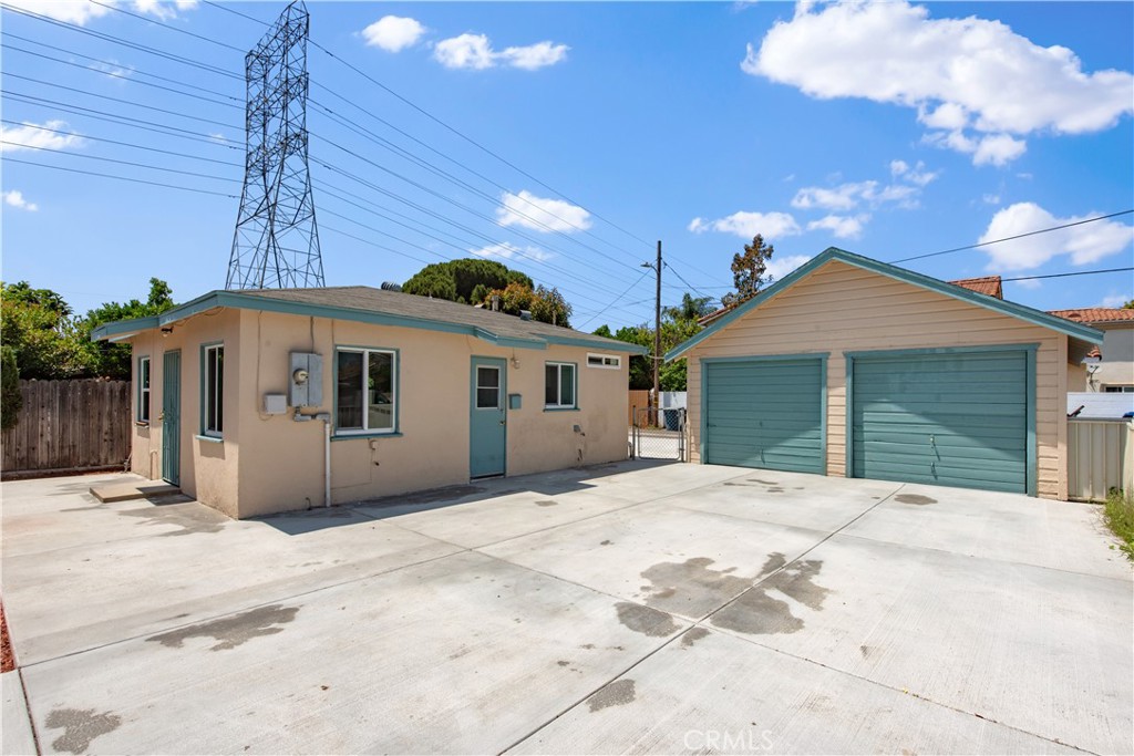 8713 Alondra Boulevard Paramount, CA 90723 - Photo 24 of 41 a front view of a house with a yard