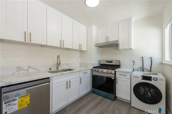 a kitchen with a sink stove and cabinets