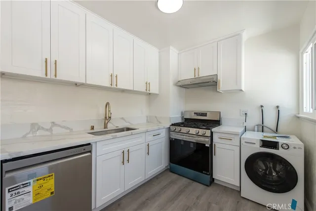 a kitchen with a sink stove and cabinets
