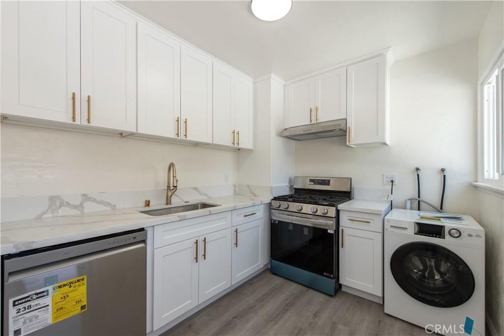 8713 Alondra Boulevard Paramount, CA 90723 - Photo 27 of 41 a kitchen with a sink stove and cabinets
