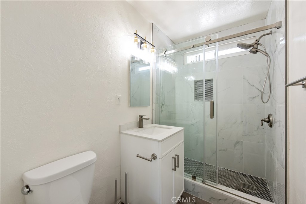 8713 Alondra Boulevard Paramount, CA 90723 - Photo 33 of 41 a bathroom with a sink toilet and shower