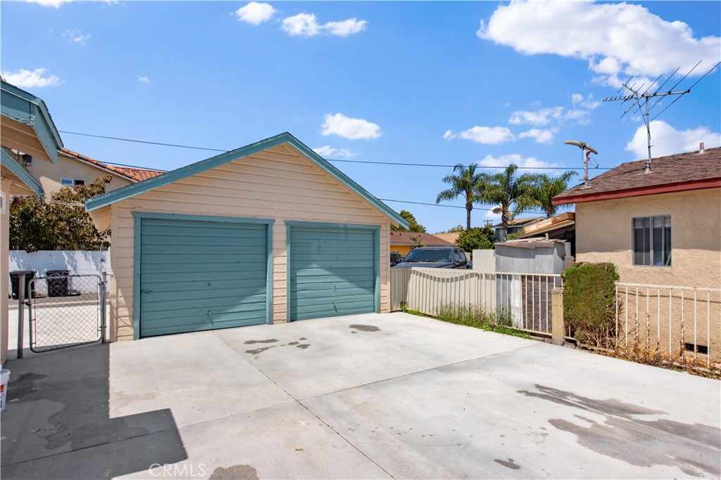 8713 Alondra Boulevard Paramount, CA 90723 - Photo 37 of 41 a front view of a house with a yard and garage