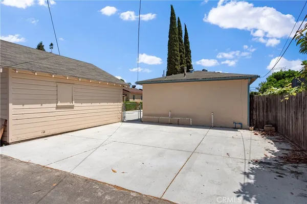 a backyard of a house with table and chairs