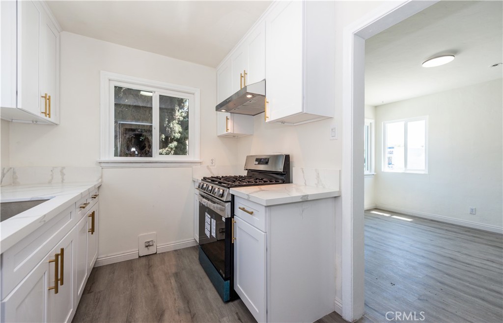 8713 Alondra Boulevard Paramount, CA 90723 - Photo 9 of 41 a kitchen with a stove and a sink