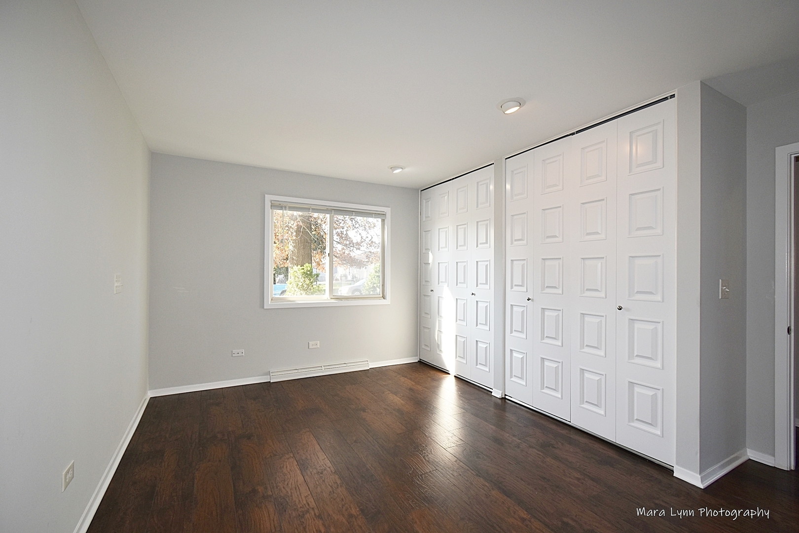 313 South Hawthorne Street Elgin, IL 60123 - Photo 15 of 22 an empty room with wooden floor and windows