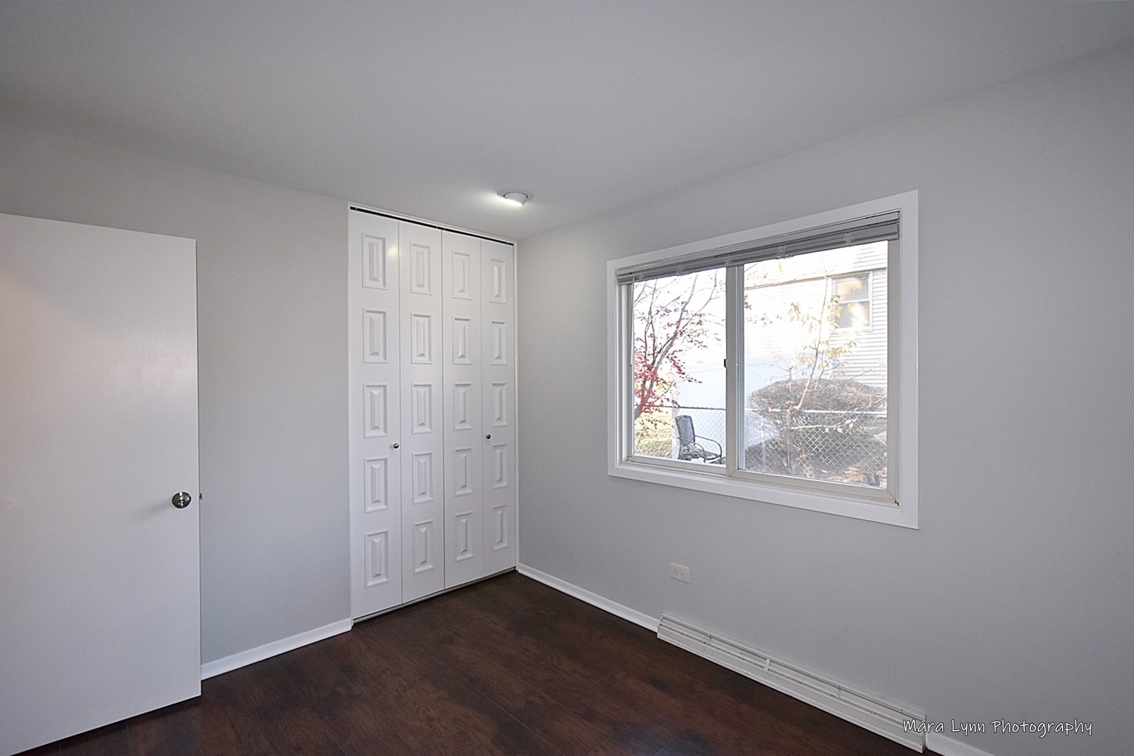 313 South Hawthorne Street Elgin, IL 60123 - Photo 18 of 22 a view of an empty room with wooden floor and a window