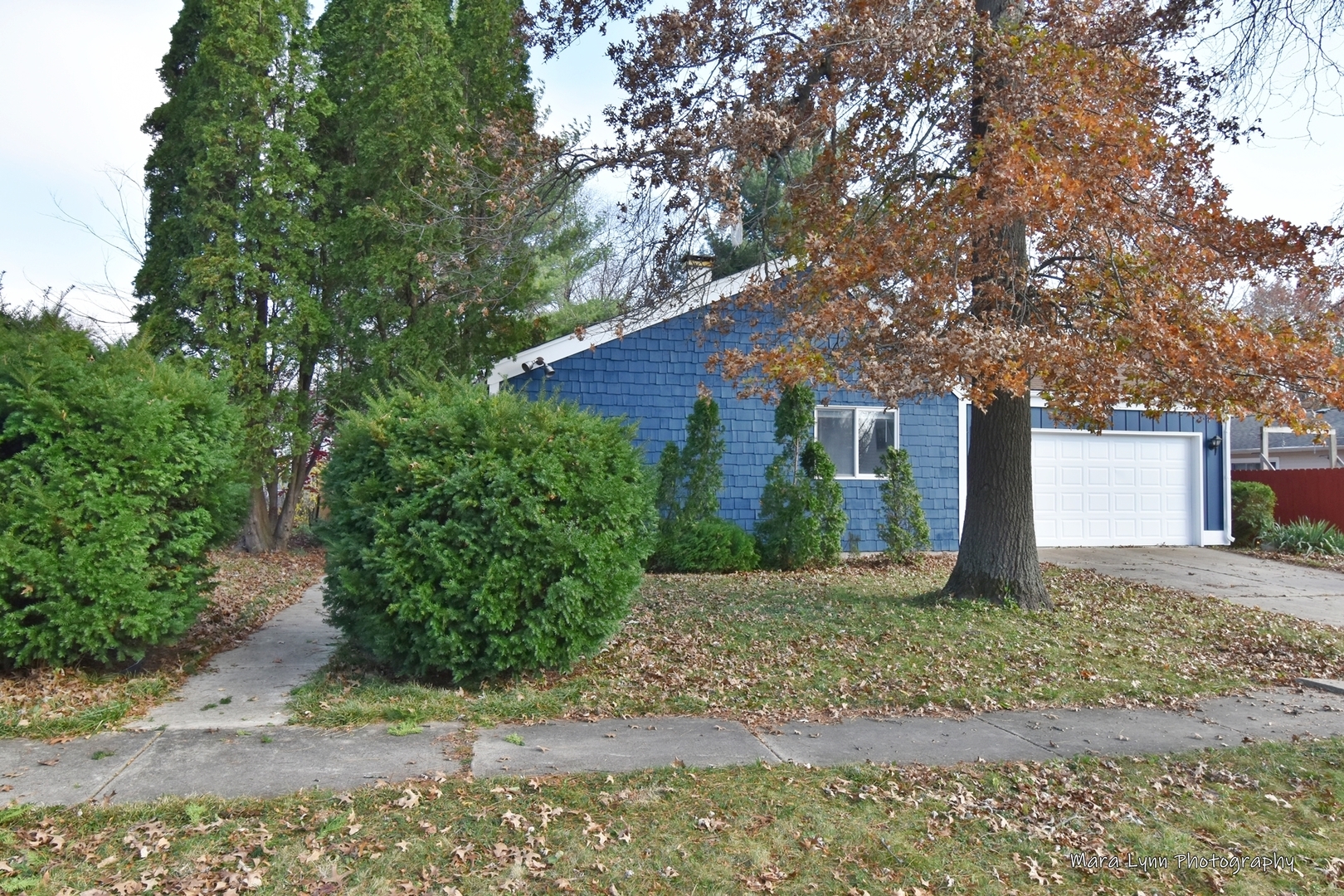 313 South Hawthorne Street Elgin, IL 60123 - Photo 22 of 22 a front view of a house with a yard and a garage