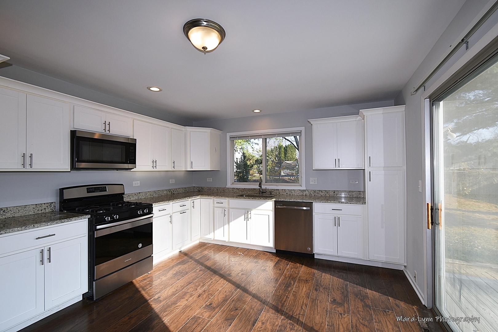 313 South Hawthorne Street Elgin, IL 60123 - Photo 4 of 22 a kitchen with granite countertop a refrigerator stove top oven and sink