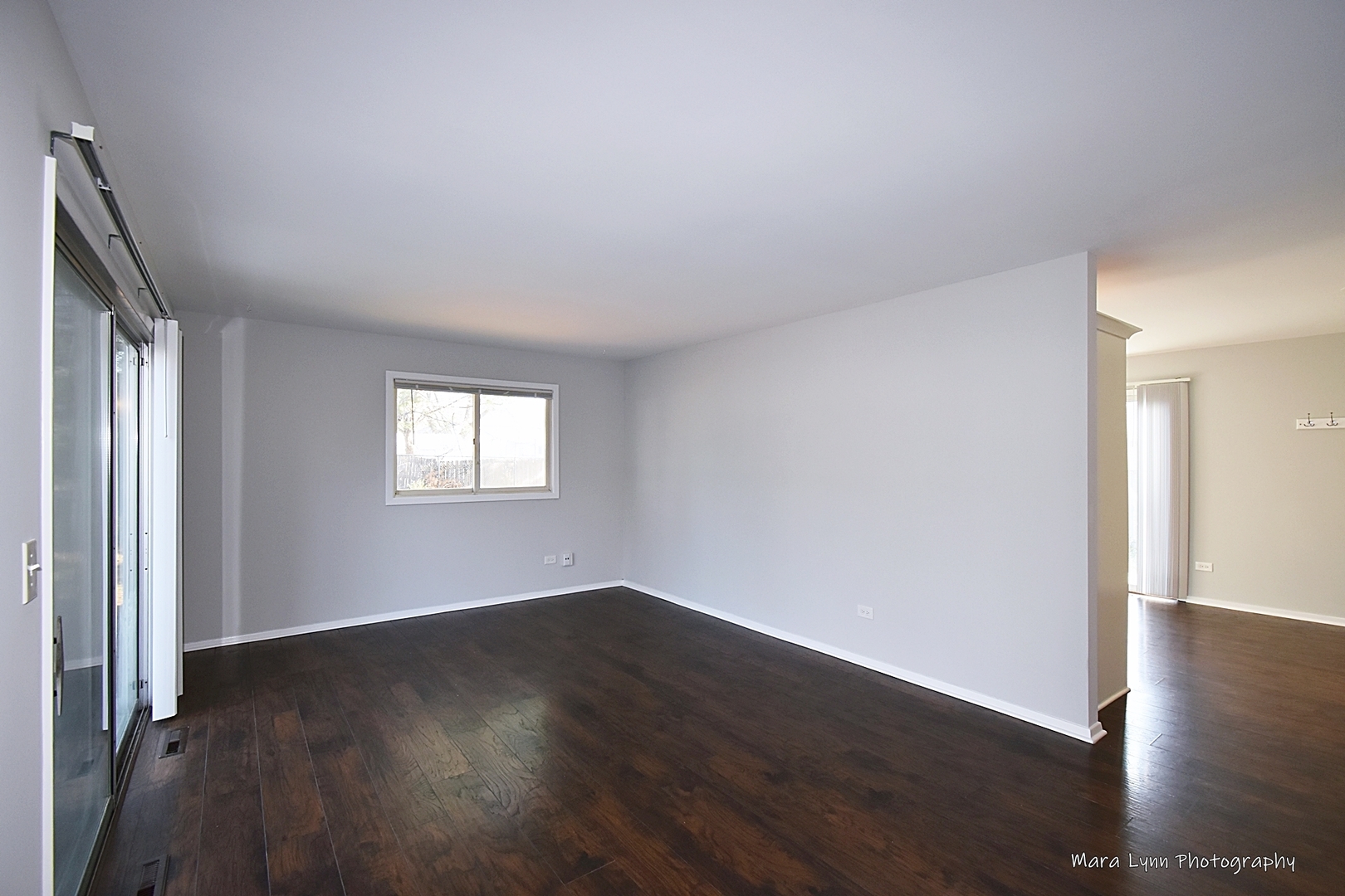 313 South Hawthorne Street Elgin, IL 60123 - Photo 8 of 22 an empty room with wooden floor and windows