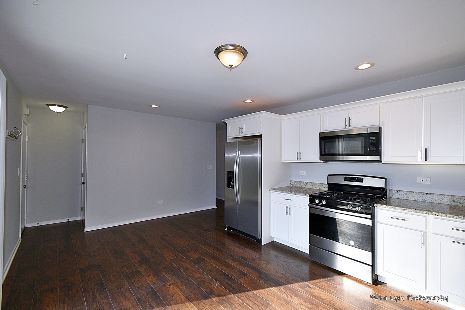 313 South Hawthorne Street Elgin, IL 60123 - Photo 10 of 22 a kitchen with granite countertop a refrigerator and a stove top oven