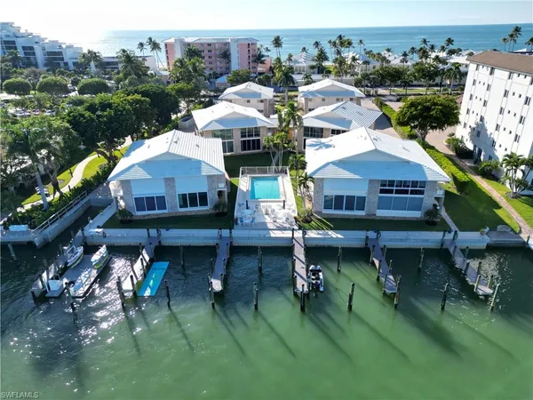 a aerial view of a house with a yard table and chairs