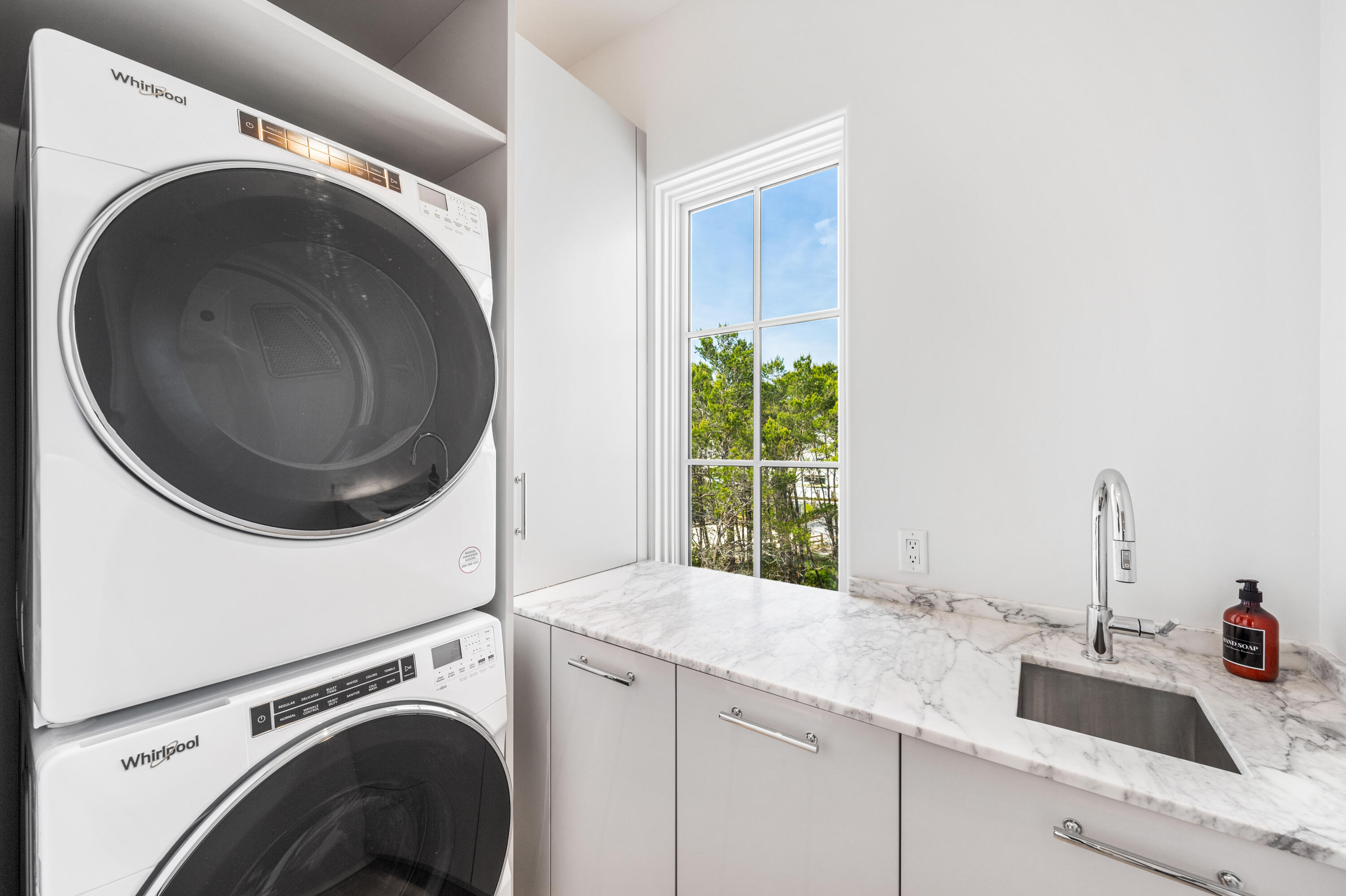 4655 East County Highway 30A Santa Rosa Beach, FL 32459 - Photo 38 of 69 a kitchen with a sink and a washer dryer