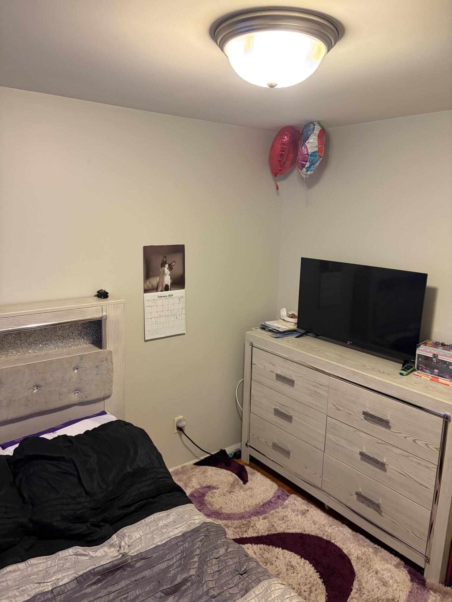 409 Holly Road Michigan City, IN 46360 - Photo 14 of 20 a bedroom with a bed and a television