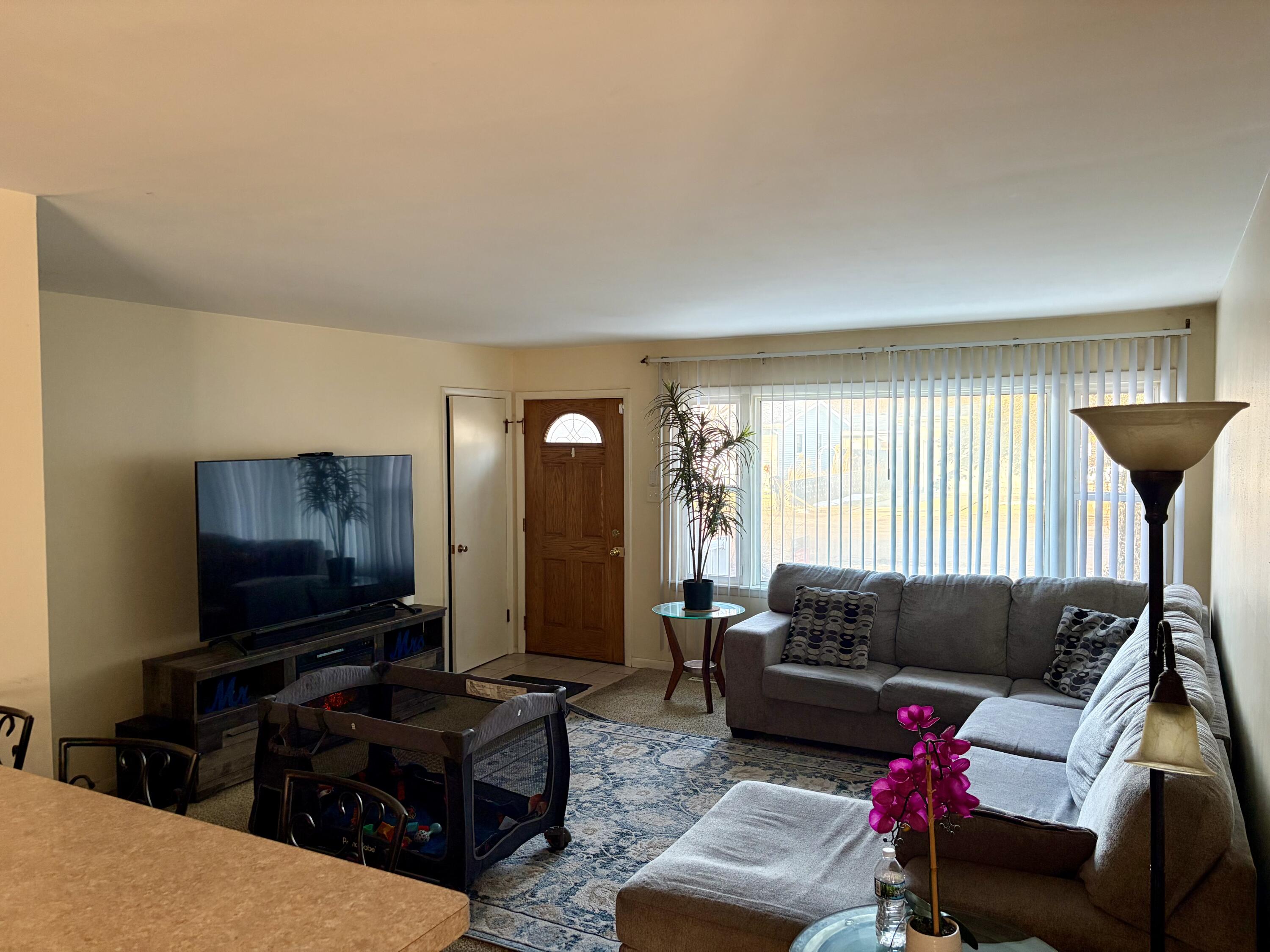 409 Holly Road Michigan City, IN 46360 - Photo 5 of 20 a living room with furniture and a flat screen tv