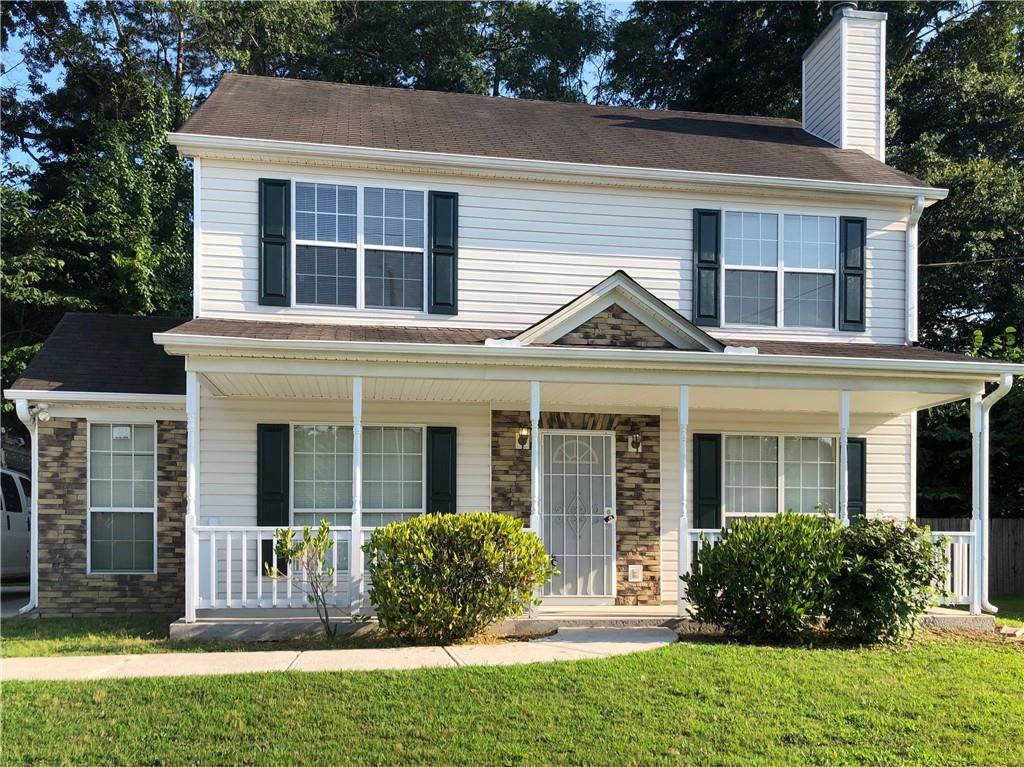963 Hunt Road Jonesboro, GA 30236 - Photo 1 of 1 a view of a brick house with a yard plants and large tree