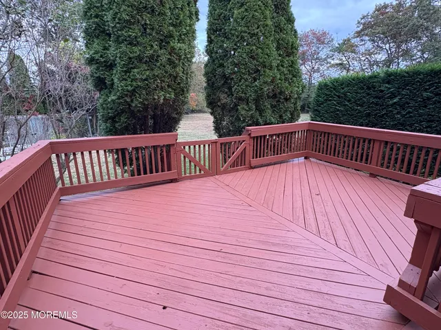 a view of balcony with wooden floor and fence