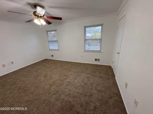 a view of room with fan and window