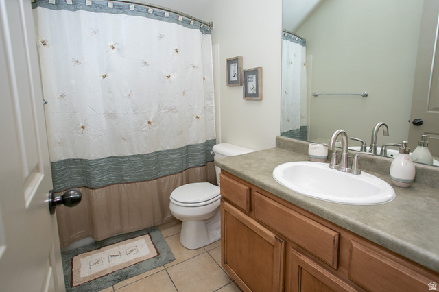 426 Deer Hollow Road Tooele, UT 84074 - Photo 18 of 37 Full bathroom featuring vanity, light tile patterned flooring, and curtained shower