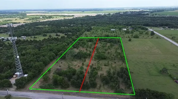 a view of a field with an ocean