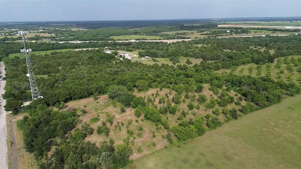 a view of a field with an ocean