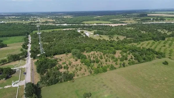 a view of a field with an ocean