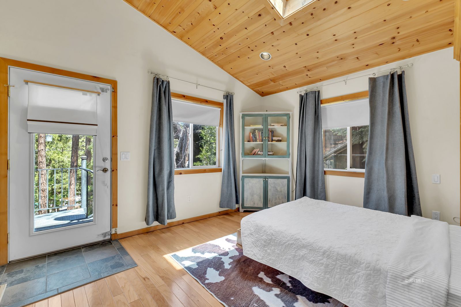 53560 Country Club Drive Idyllwild, CA 92549 - Photo 15 of 66 a bedroom with a large bed and a window