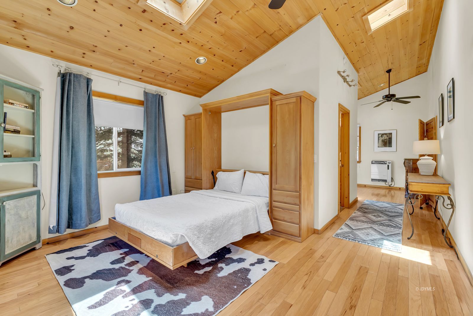 53560 Country Club Drive Idyllwild, CA 92549 - Photo 16 of 66 a bedroom with a bed and wooden floor