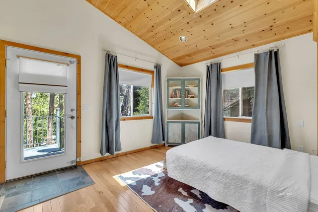 a view of a patio with a table chairs and wooden floor