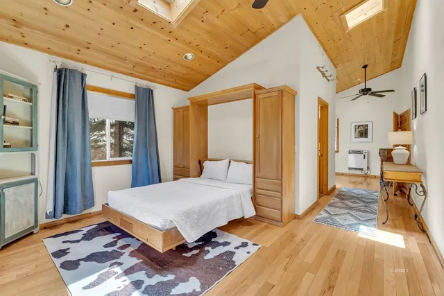 a view of a patio with table and chairs with wooden floor and fence