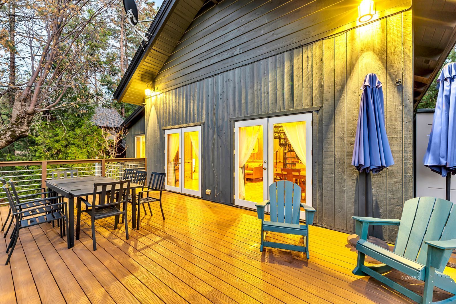 53560 Country Club Drive Idyllwild, CA 92549 - Photo 30 of 66 a view of a patio with a table chairs and wooden floor