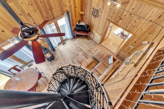 a porch with a table under an roof deck