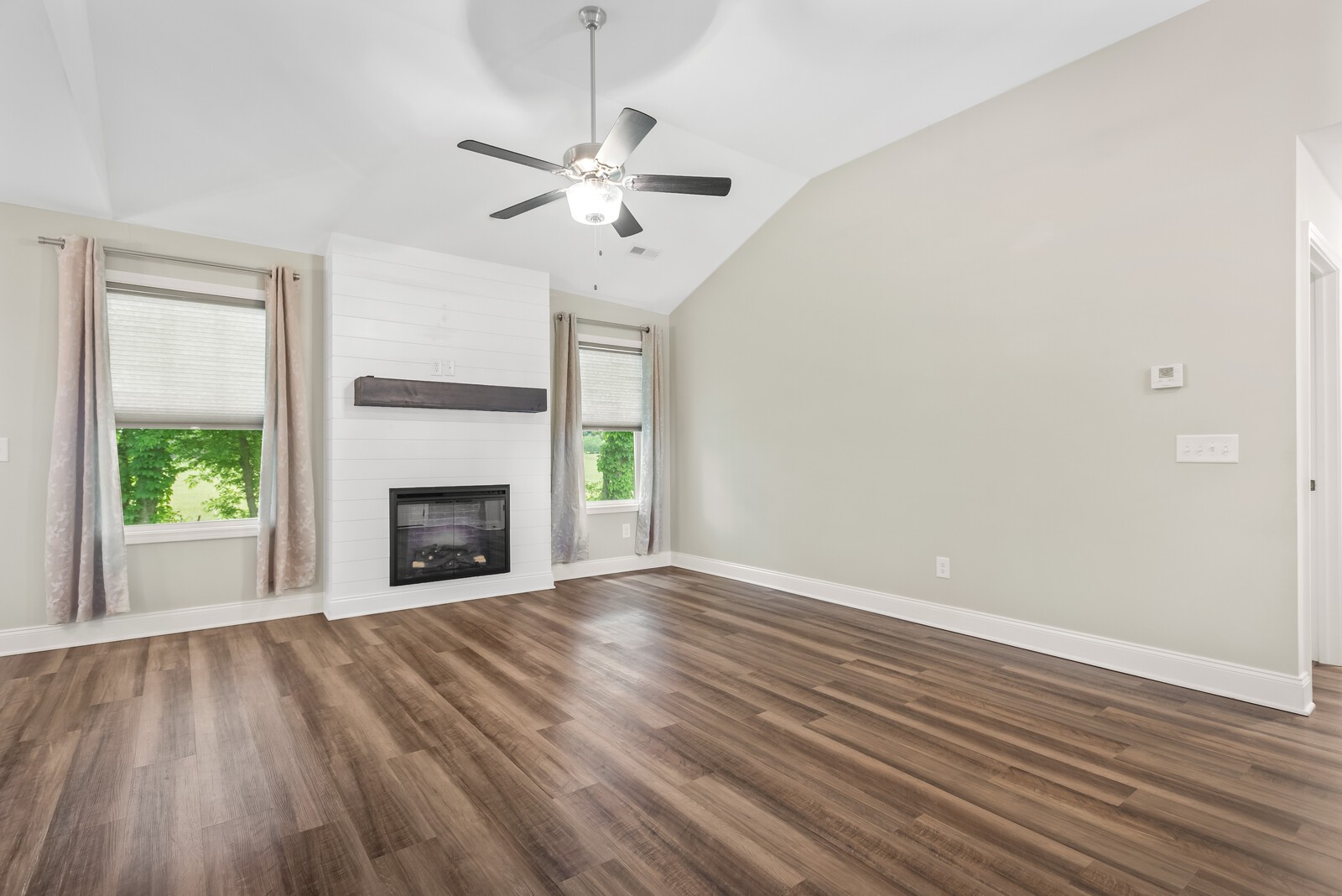 357 Fieldstone Lane Springfield, TN 37172 - Photo 15 of 46 an empty room with wooden floor fireplace and windows