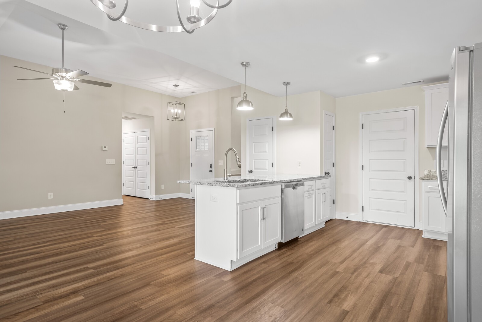357 Fieldstone Lane Springfield, TN 37172 - Photo 16 of 46 a large kitchen with white cabinets stainless steel appliances and wooden floor