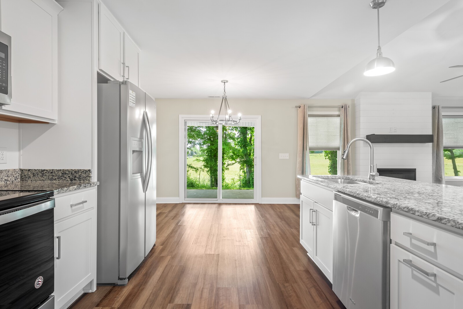 357 Fieldstone Lane Springfield, TN 37172 - Photo 22 of 46 a kitchen with stainless steel appliances granite countertop a stove a refrigerator a sink and white cabinets with wooden floor
