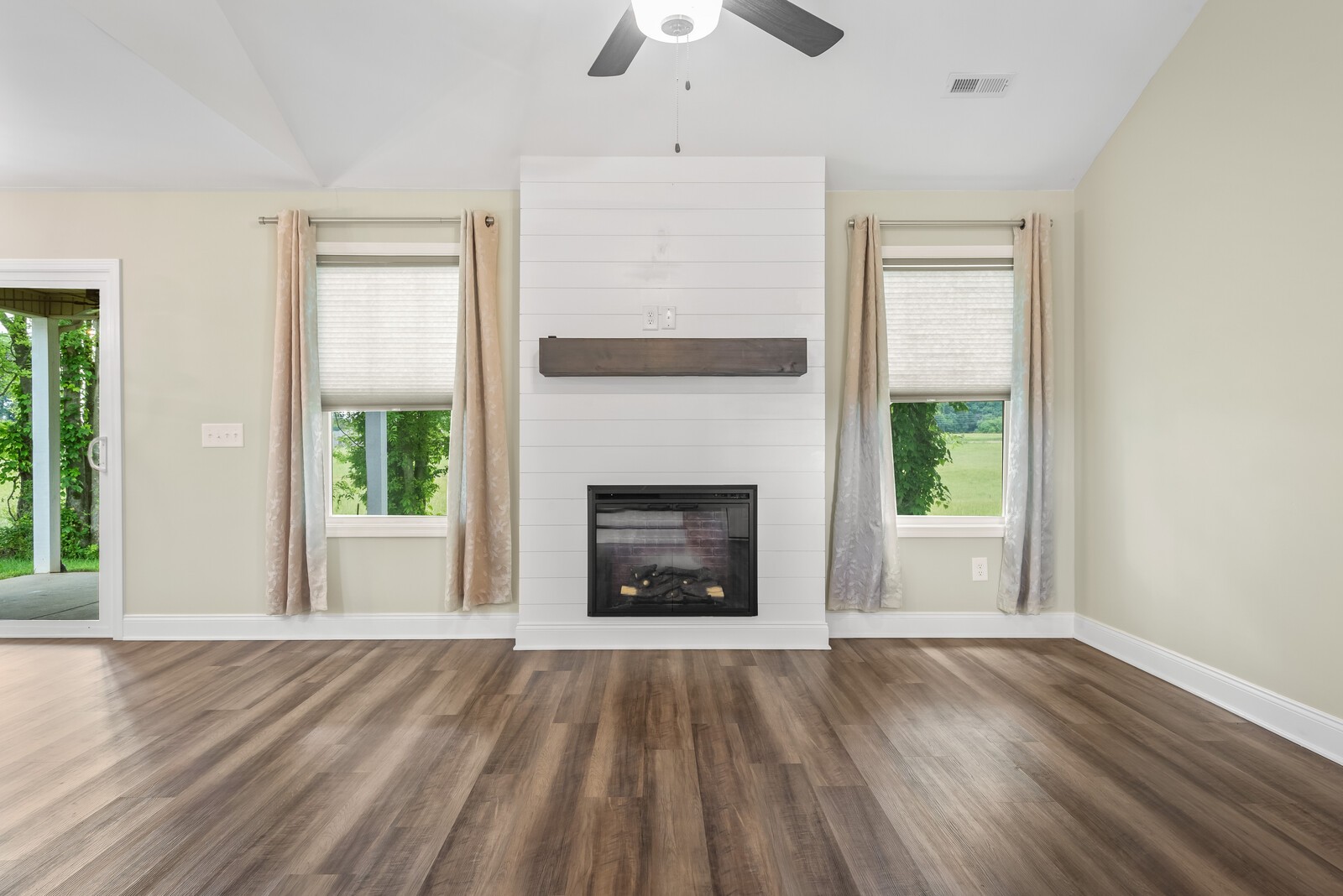 357 Fieldstone Lane Springfield, TN 37172 - Photo 4 of 46 a view of an empty room with wooden floor fireplace and a window