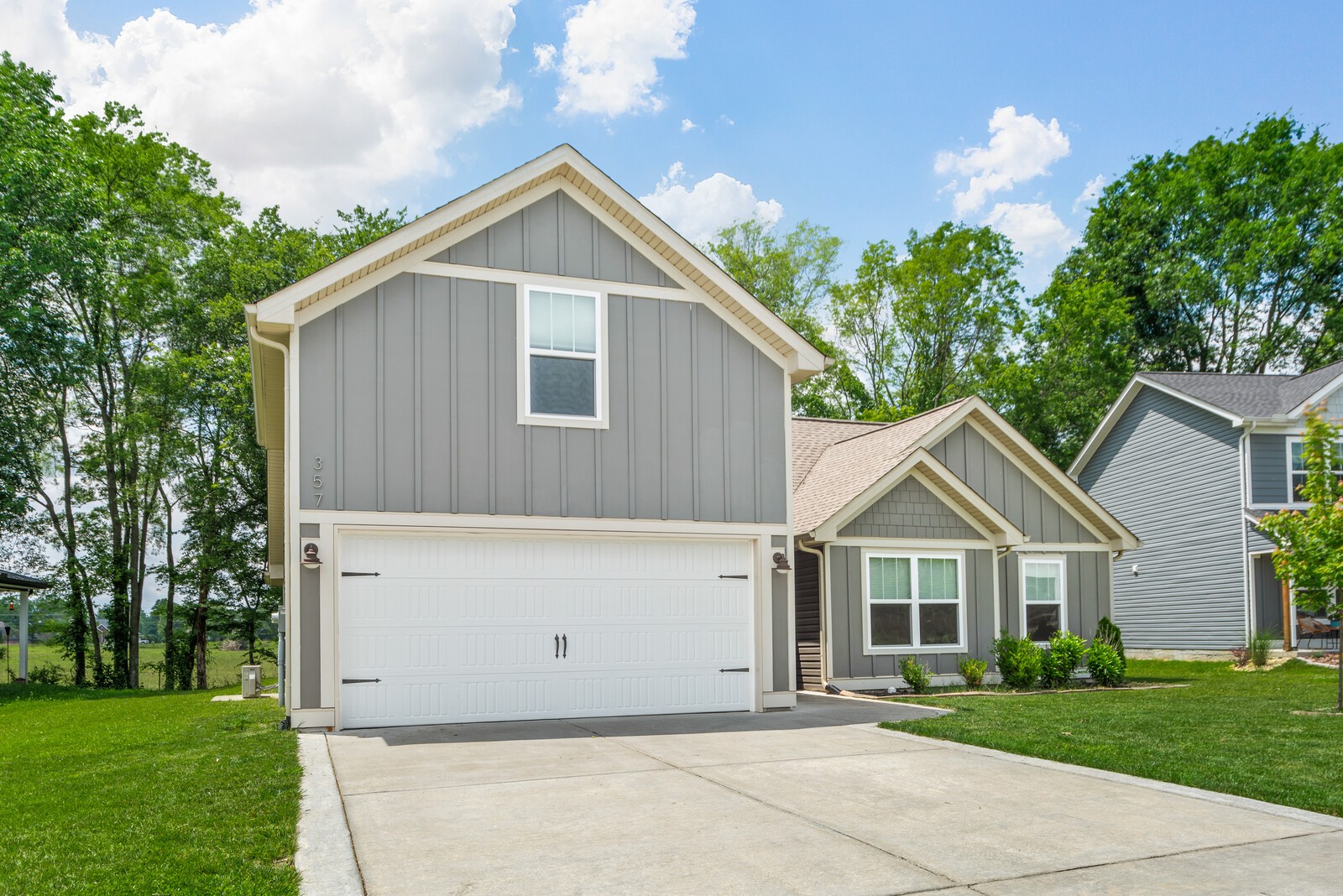 357 Fieldstone Lane Springfield, TN 37172 - Photo 7 of 46 a view of a white house next to a yard with big trees