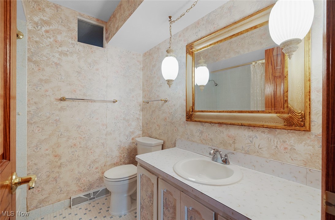5611 Ralston Drive Parma, OH 44129 - Photo 20 of 39 Bathroom featuring wallpapered walls and vanity