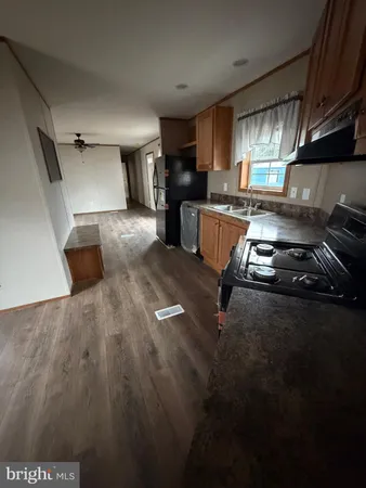 a kitchen with granite countertop a stove and a refrigerator