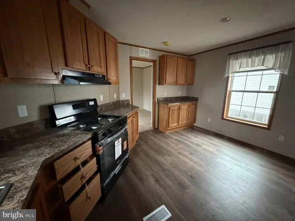 a kitchen with granite countertop a stove and a sink