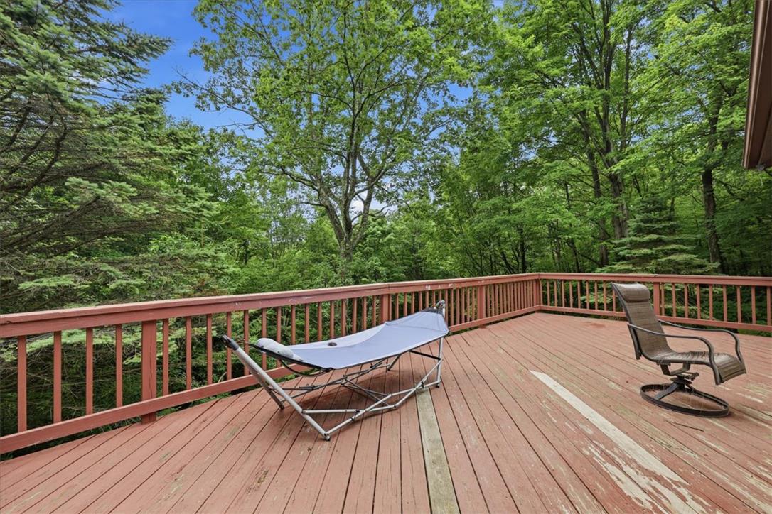 520 Highland Hill Road Jim Thorpe, PA 18235 - Photo 54 of 83 A spacious wooden deck provides a serene outdoor living area, perfectly nestled among verdant trees.