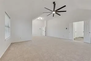 an empty room with closet and a chandelier fan