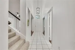 a view of a hallway with windows and stairs