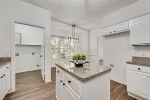 a kitchen with stainless steel appliances granite countertop a sink and a refrigerator