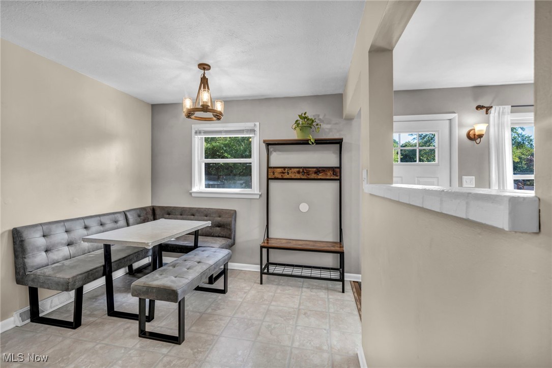 1641 Slusser Road Akron, OH 44305 - Photo 9 of 34 Dining room with healthy amount of natural light and a chandelier