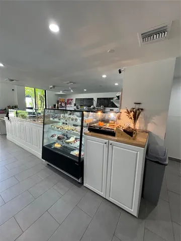 a kitchen with stainless steel appliances kitchen island granite countertop a refrigerator and stove