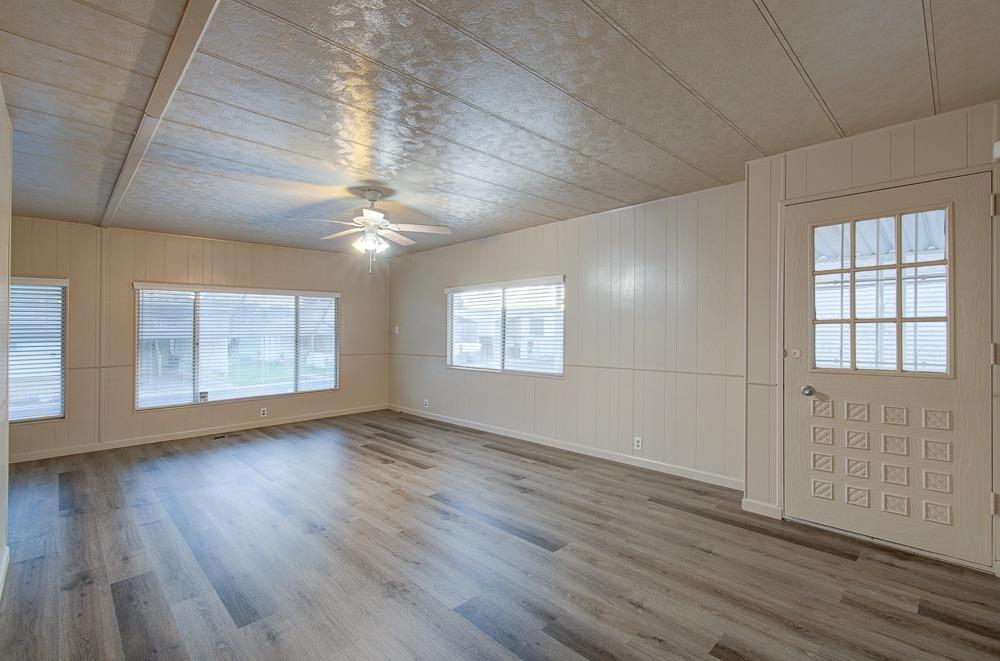 1500 Villa Avenue, Unit 27 Clovis, CA 93612 - Photo 11 of 29 an empty room with wooden floor and windows