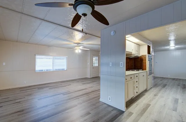 a view of a refrigerator in kitchen and wooden floor