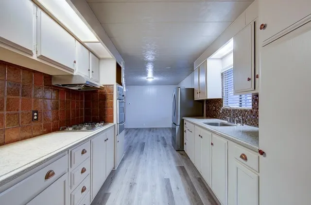 an empty room with a empty space and windows