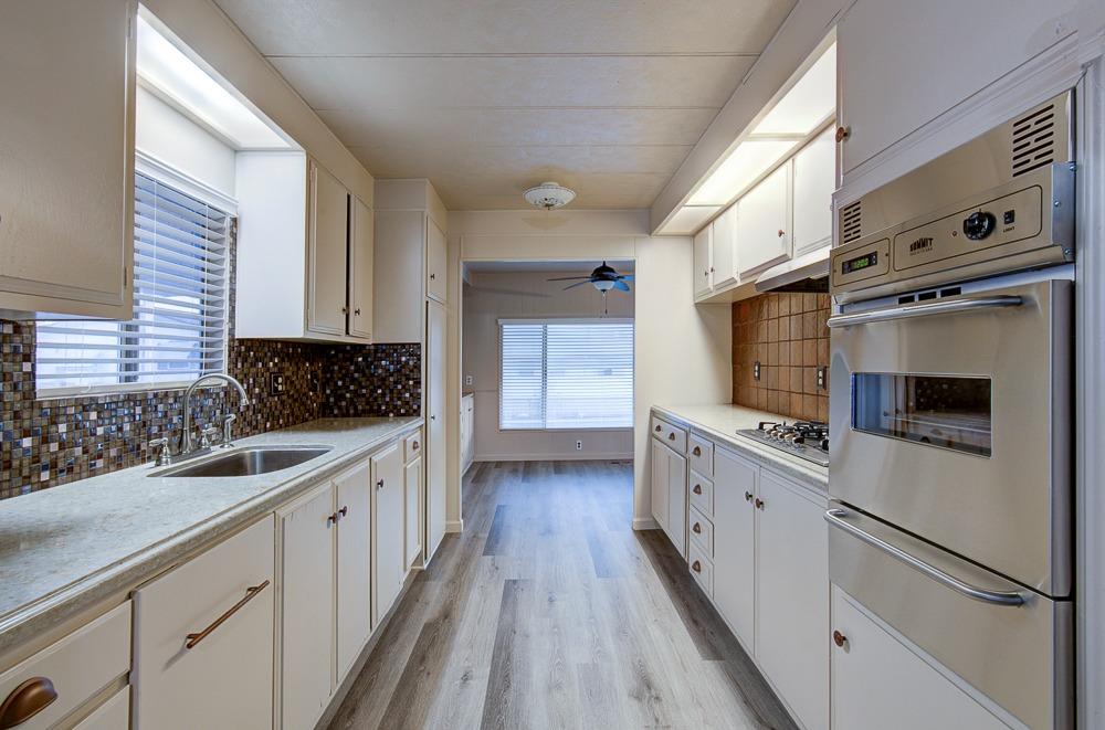 1500 Villa Avenue, Unit 27 Clovis, CA 93612 - Photo 18 of 29 a kitchen with granite countertop a sink and cabinets