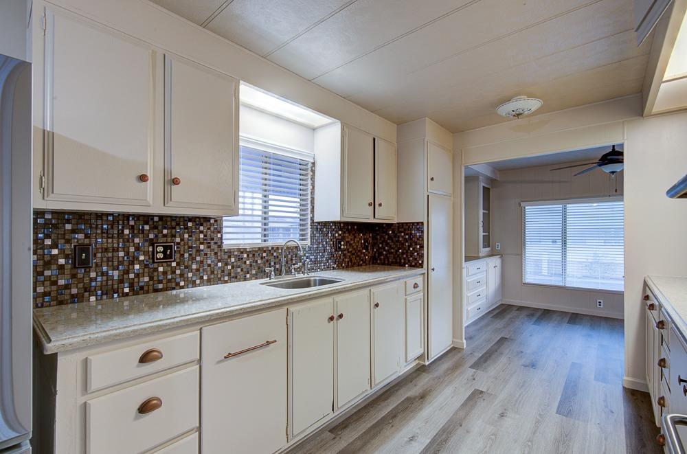 1500 Villa Avenue, Unit 27 Clovis, CA 93612 - Photo 19 of 29 a kitchen with granite countertop white cabinets and white appliances